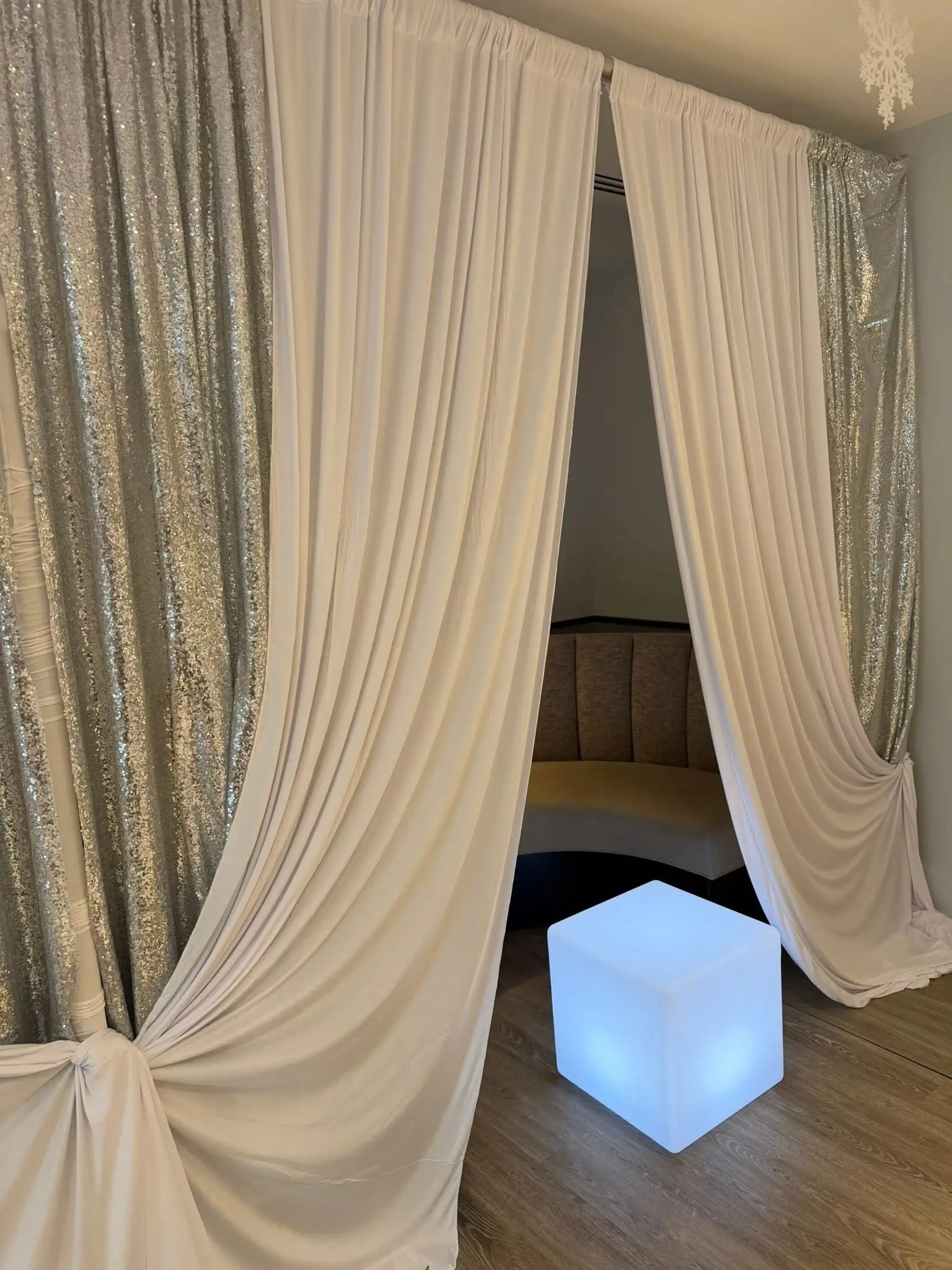 Elegant birthday decor setup with drapery and balloons