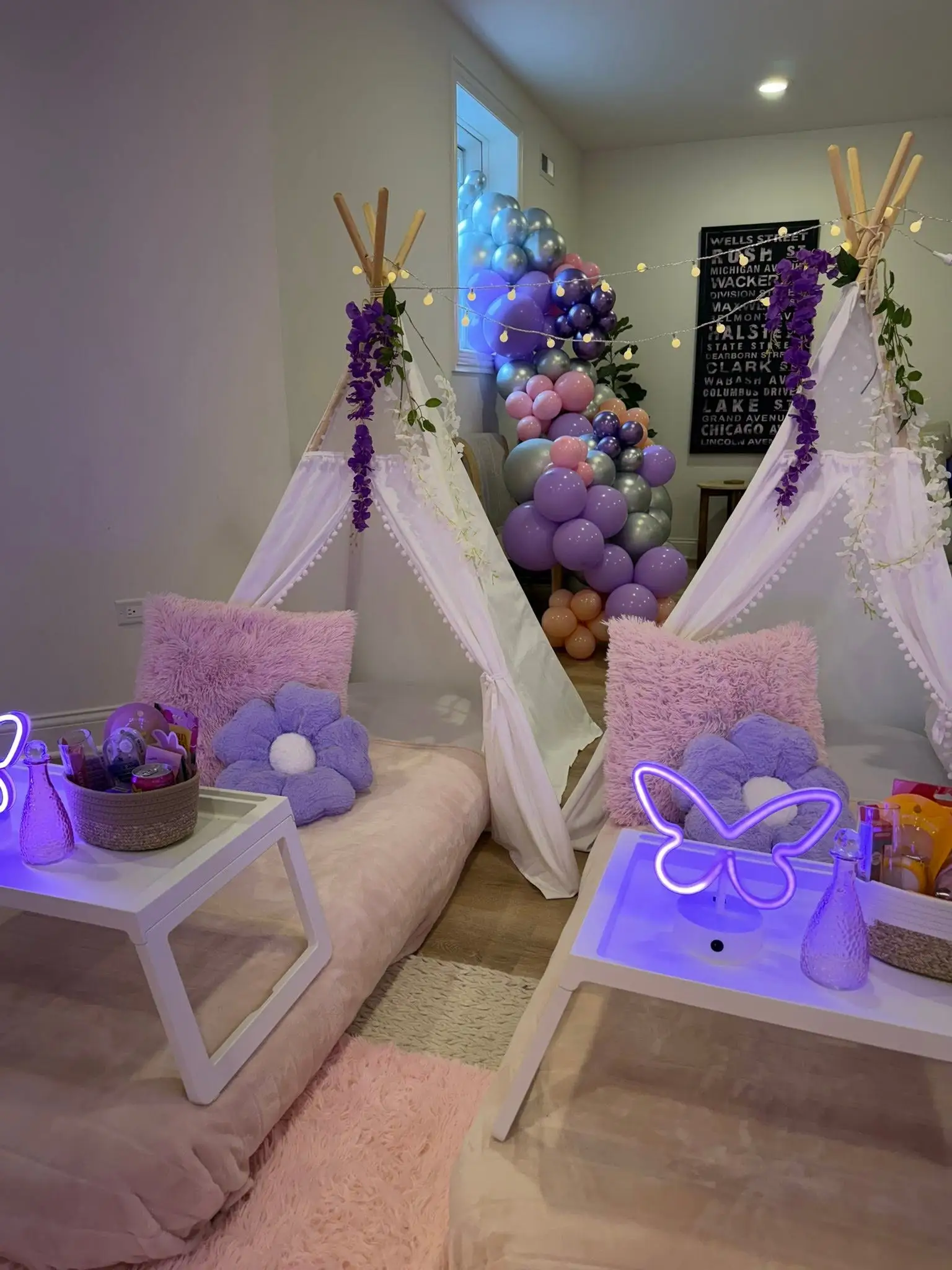 Sleepover party decor details with lavender balloons and blush backdrop styling