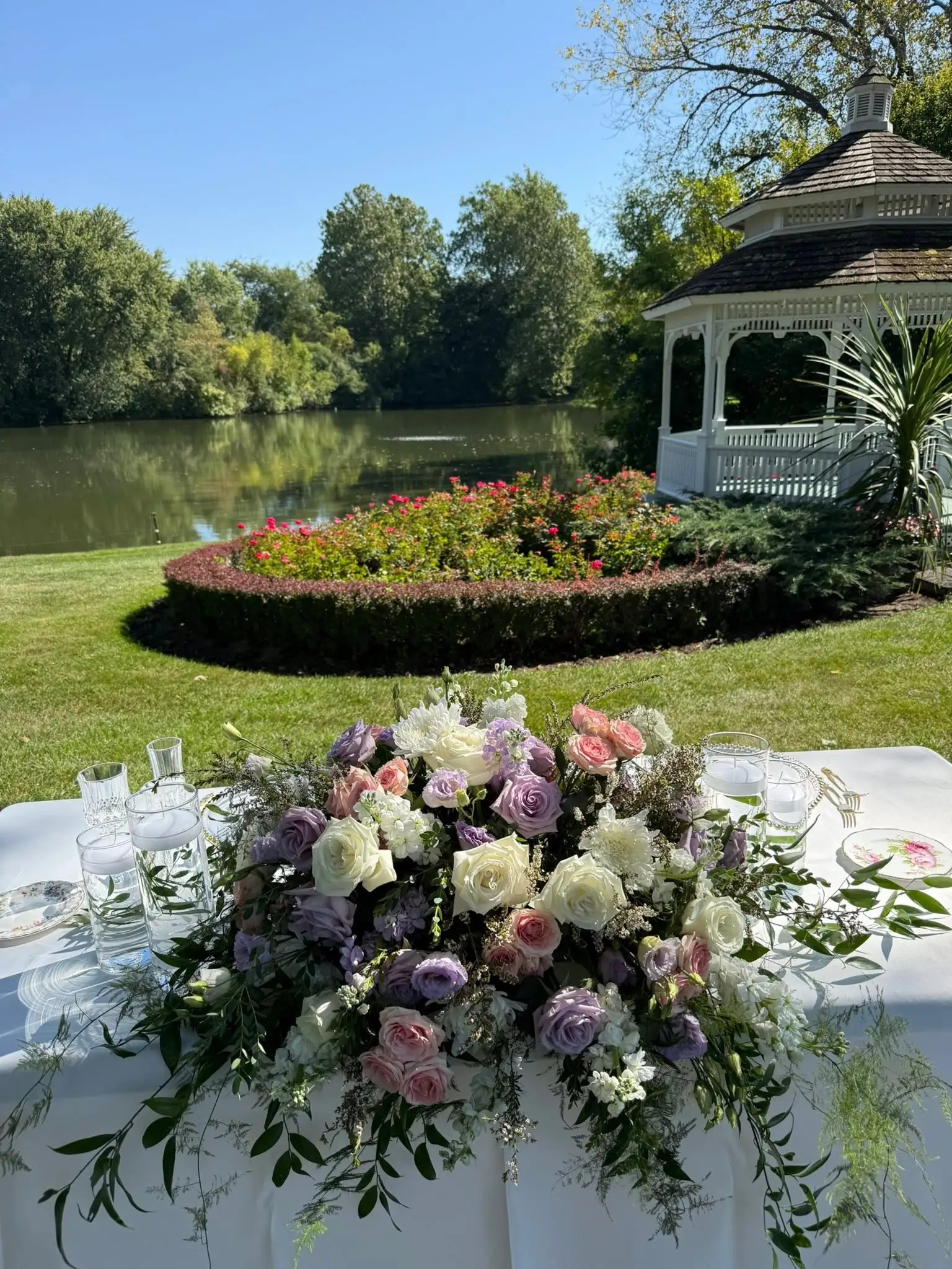 Romantic wedding venue decor in Chicago with pastel florals, white table linens and a garden venue