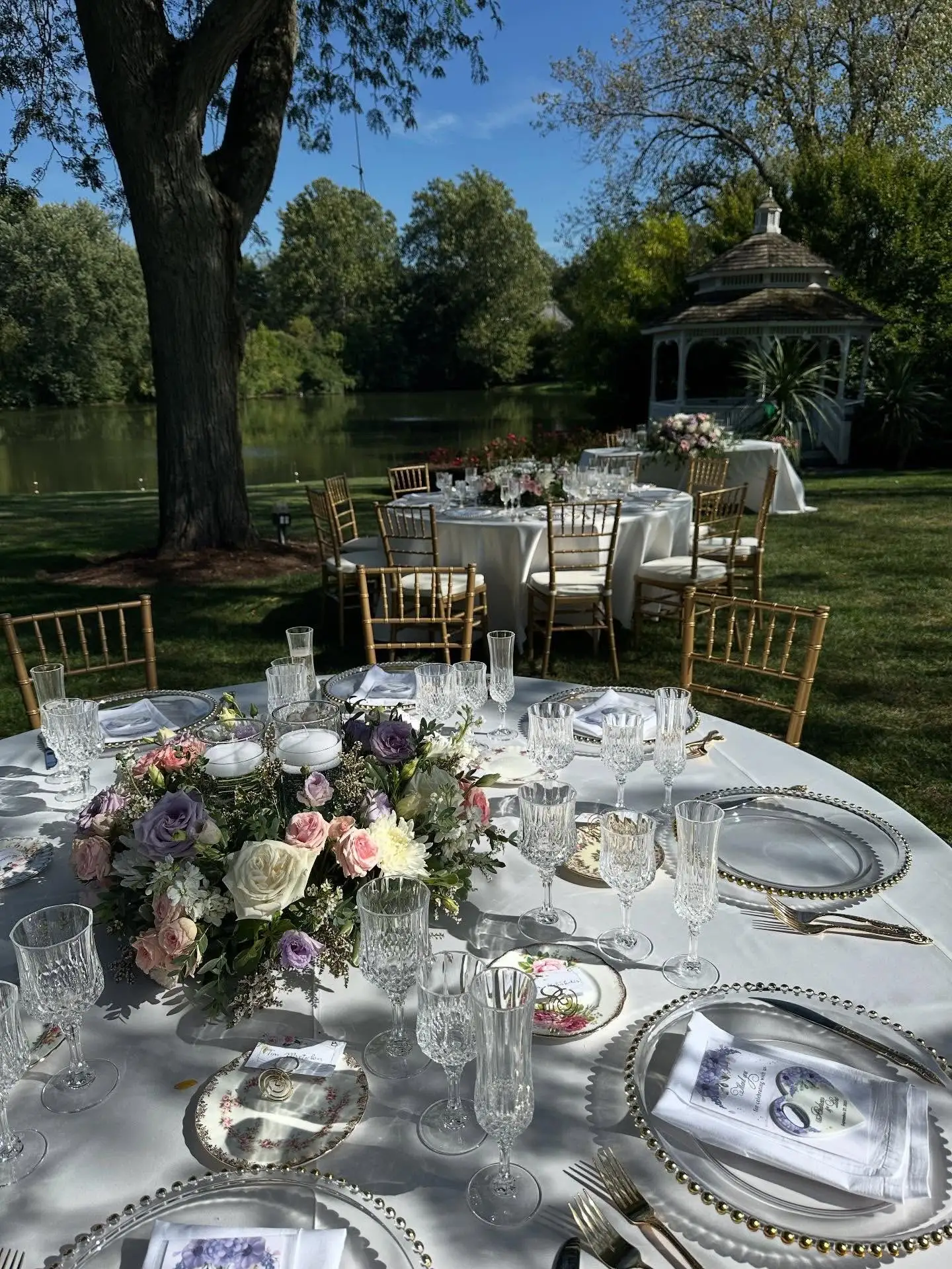 Elegant wedding table decor with white linens, glassware and soft floral design
